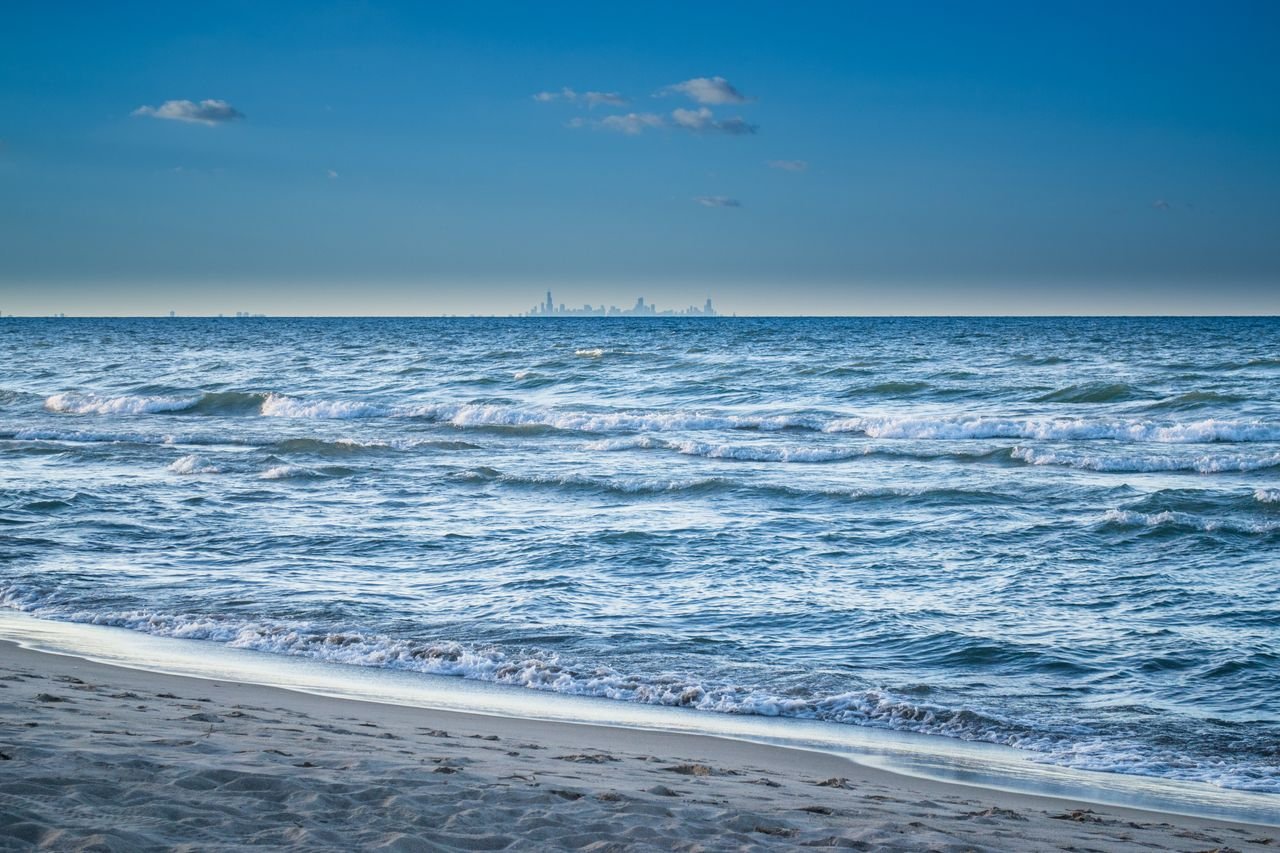 service-03 Serene ocean view with city skyline in the distance, perfect for peaceful seascape lovers.